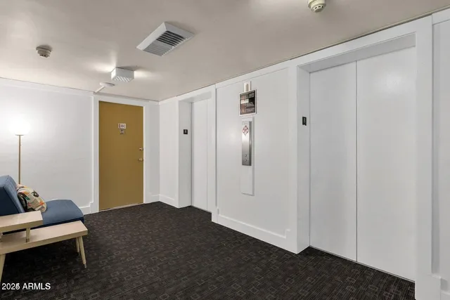 a lobby with furniture and a potted plant