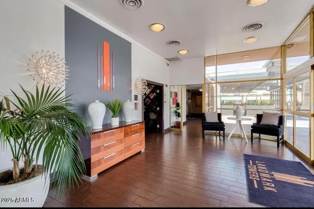 a view of a room with furniture and wooden floor
