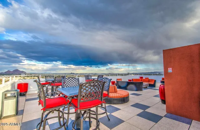 a backyard of a house with barbeque oven table and chairs