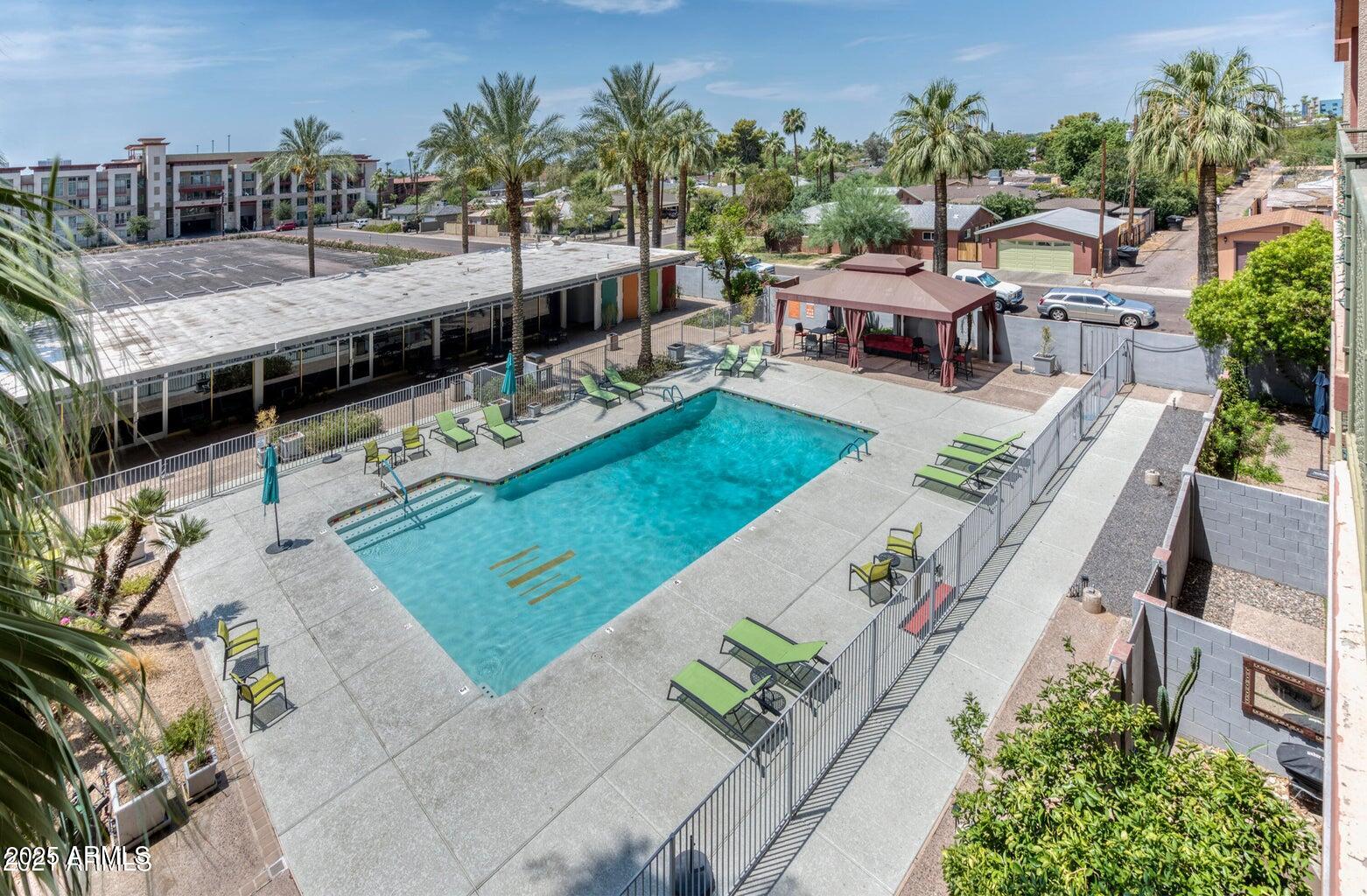 4750 North Central Avenue, Unit L8 Phoenix, AZ 85012 - Photo 38 of 55 a view of a swimming pool with lounge chairs in patio