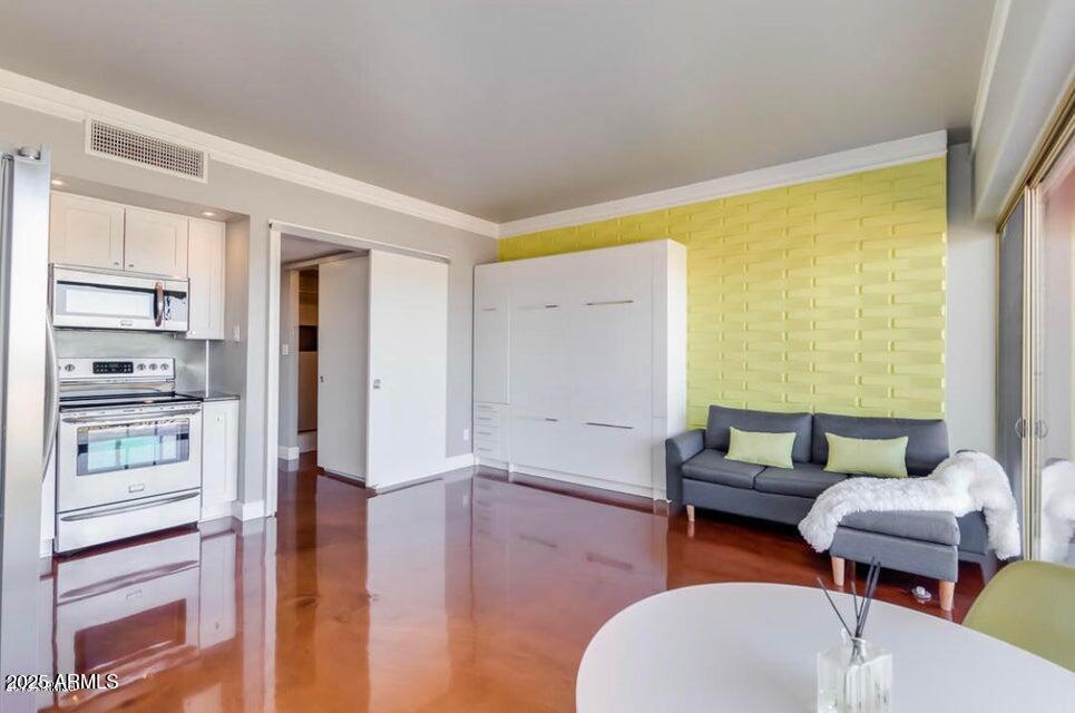 4750 North Central Avenue, Unit L8 Phoenix, AZ 85012 - Photo 6 of 55 a living room with furniture and a wooden floor