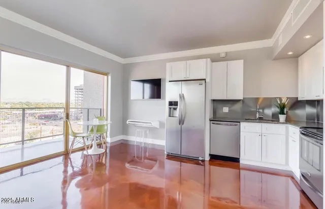a kitchen with stainless steel appliances a refrigerator and a stove top oven