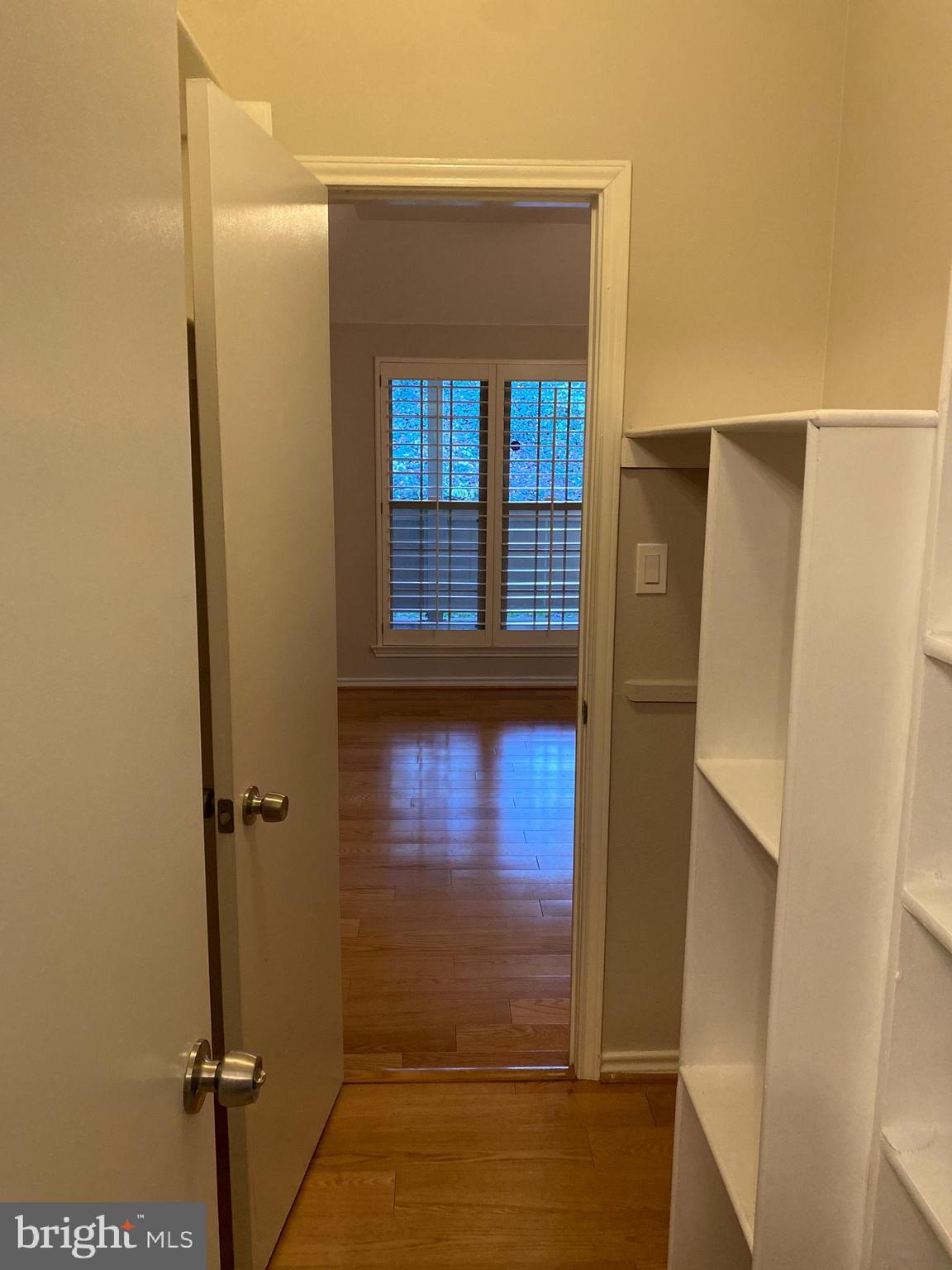 12161 Penderview Terrace, Unit 906 Fairfax, VA 22033 - Photo 11 of 20 a view of a hallway with a glass door and a window