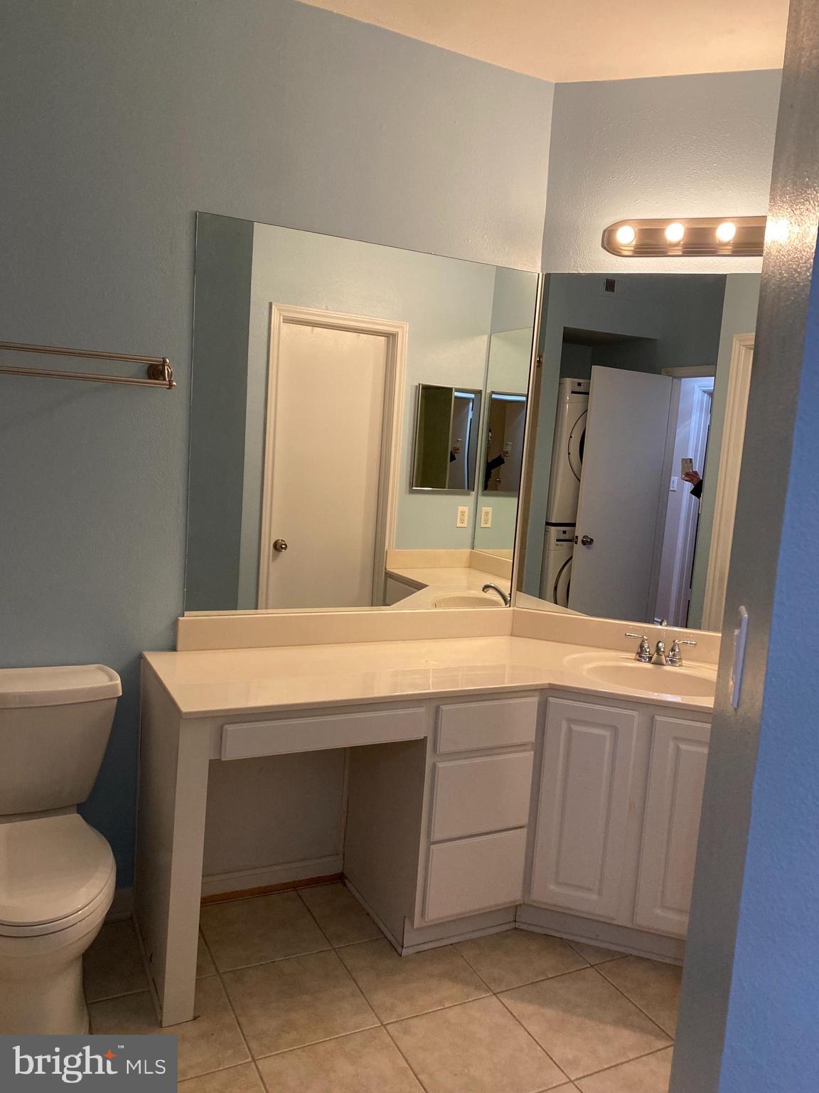 12161 Penderview Terrace, Unit 906 Fairfax, VA 22033 - Photo 16 of 20 a bathroom with a toilet sink and mirror