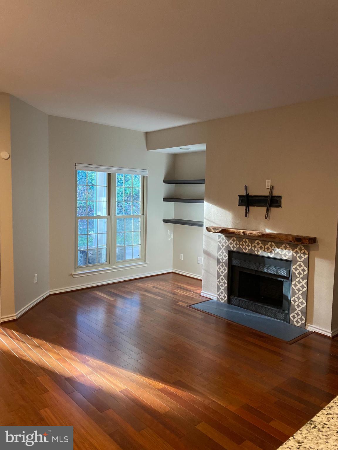 12161 Penderview Terrace, Unit 906 Fairfax, VA 22033 - Photo 5 of 20 a living room with hard wood floors and a fireplace