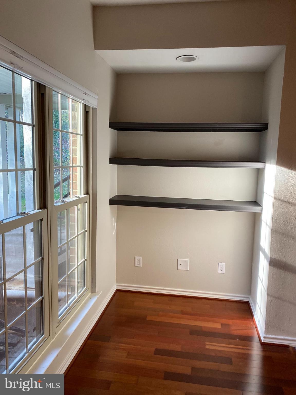 12161 Penderview Terrace, Unit 906 Fairfax, VA 22033 - Photo 6 of 20 a view of empty room with wooden floor and windows