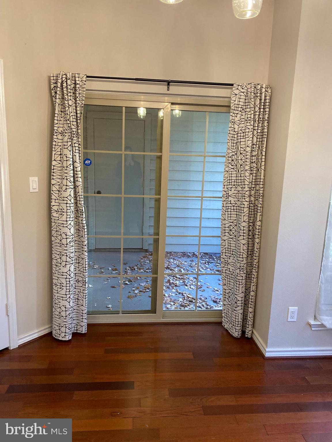 12161 Penderview Terrace, Unit 906 Fairfax, VA 22033 - Photo 9 of 20 a view of an empty room with wooden floor and a window