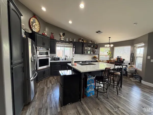 a kitchen with granite countertop a stainless steel appliances and a refrigerator