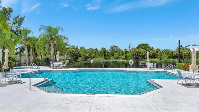a view of a city with lots of residential buildings ocean and mountain view in back