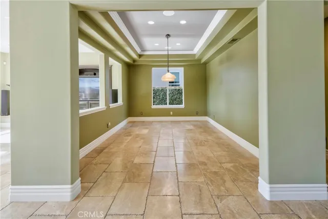 a view of a patio with couches table and chairs potted plants and palm tree