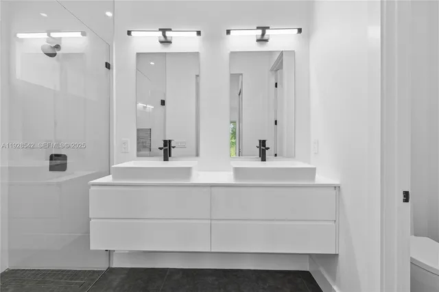 a bathroom with a sink vanity and mirror