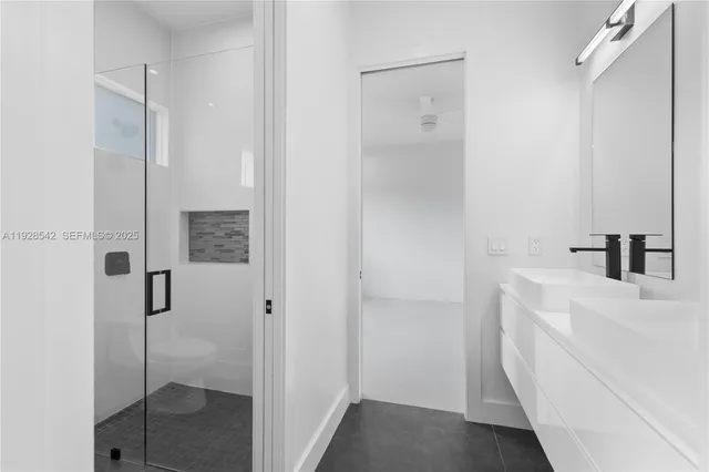 a bathroom with a shower and a sink