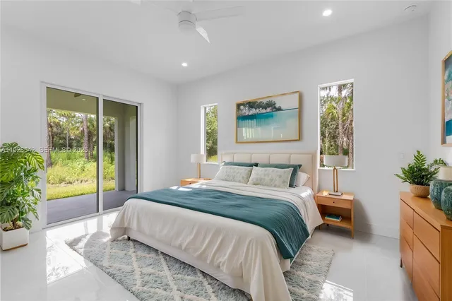 a bedroom with a large bed and a large window