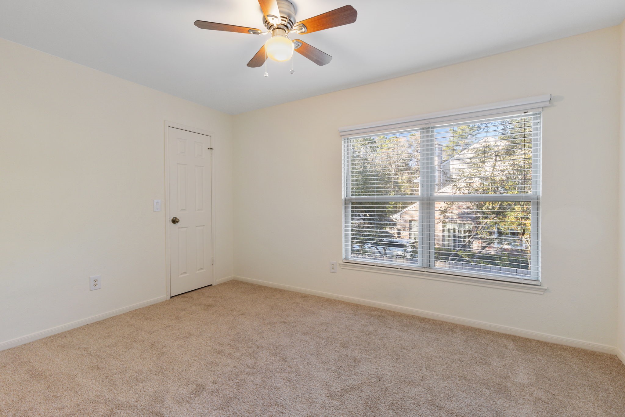 59 Fire Flicker Place Spring, TX 77381 - Photo 28 of 37 Bedroom four, with new ceiling fan and large window.