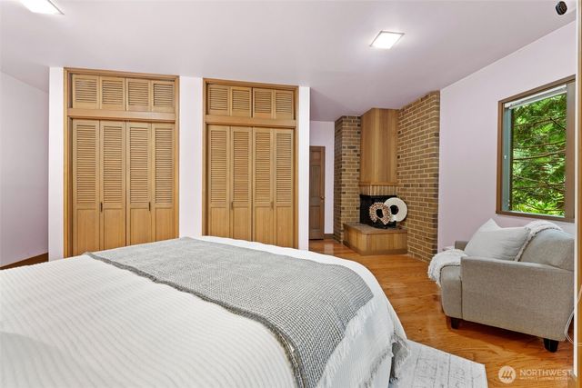 a spacious bedroom with a bed and glass window