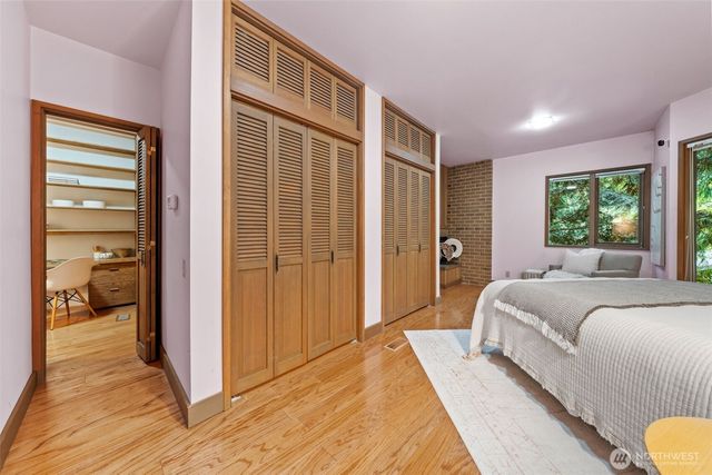 a spacious bedroom with a large bed and a window