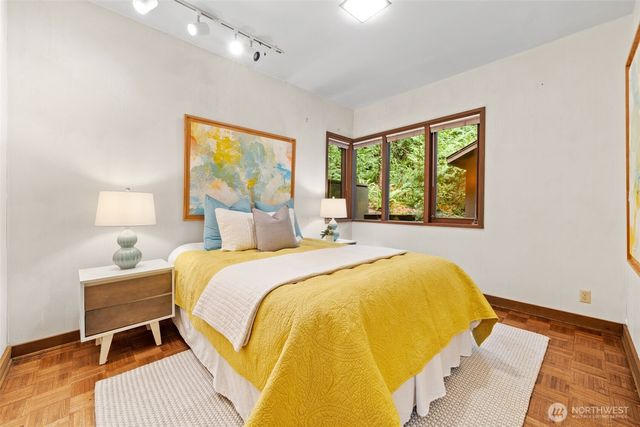 a bedroom with a bed and a painting on the wall