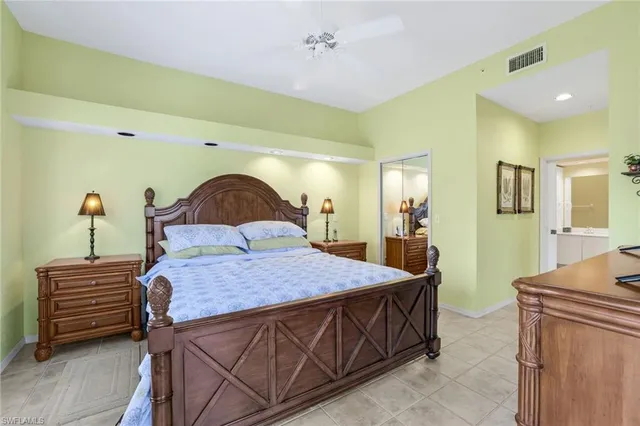 a bedroom with a bed and a dresser in it