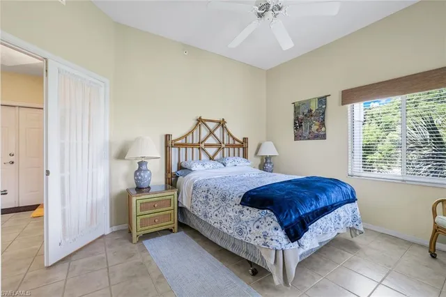 a spacious bedroom with a bed and a chandelier