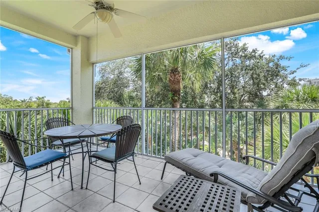 a view of a balcony with furniture and wooden floor