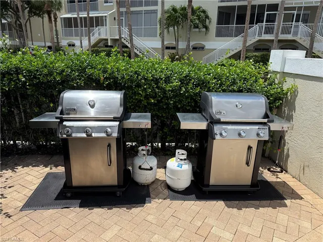 a view of a patio with table and chairs and potted plants