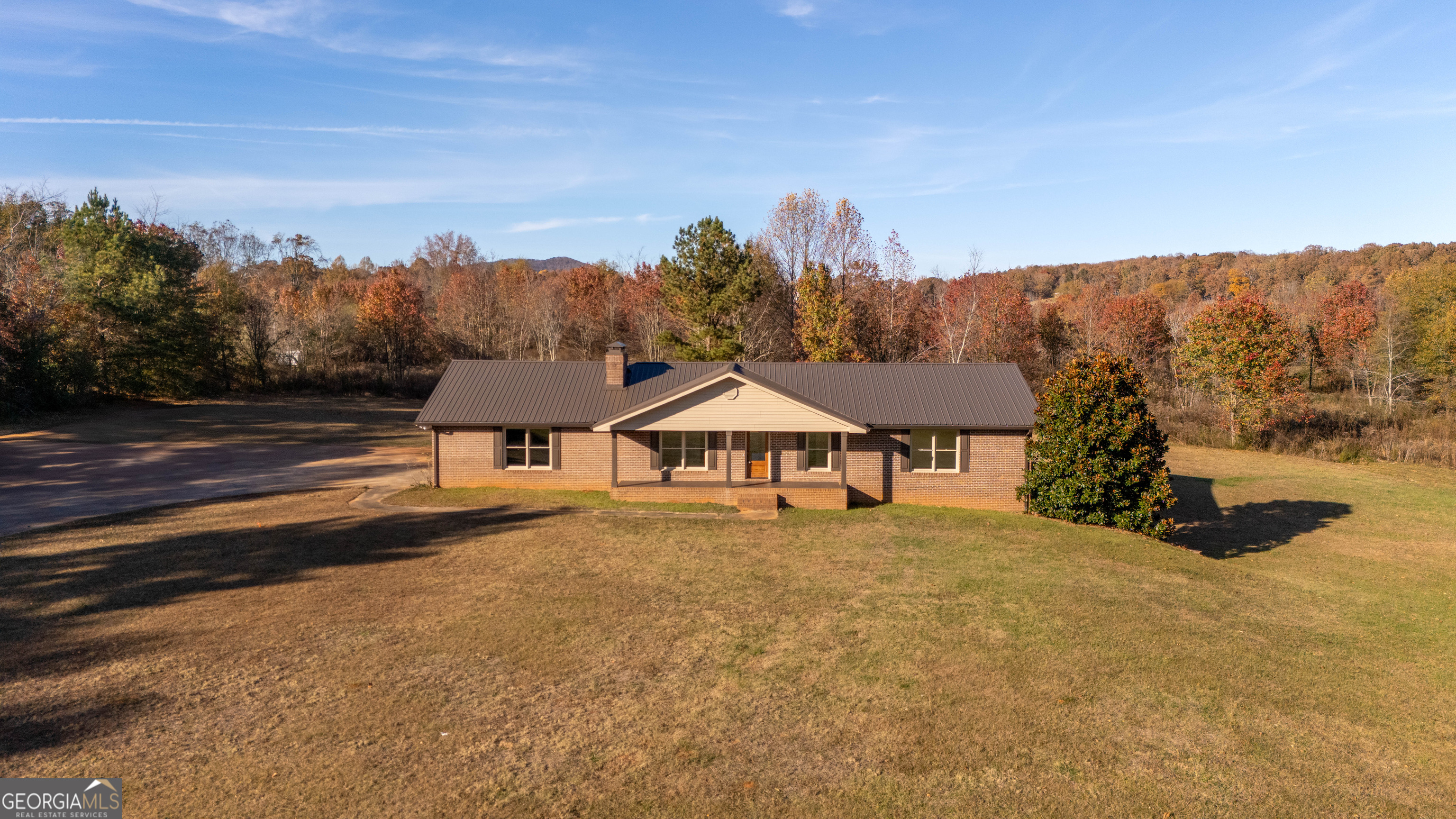 6421 Holly Springs Road Clermont, GA 30527 - Photo 1 of 58 a front view of a house with a yard and mountain view