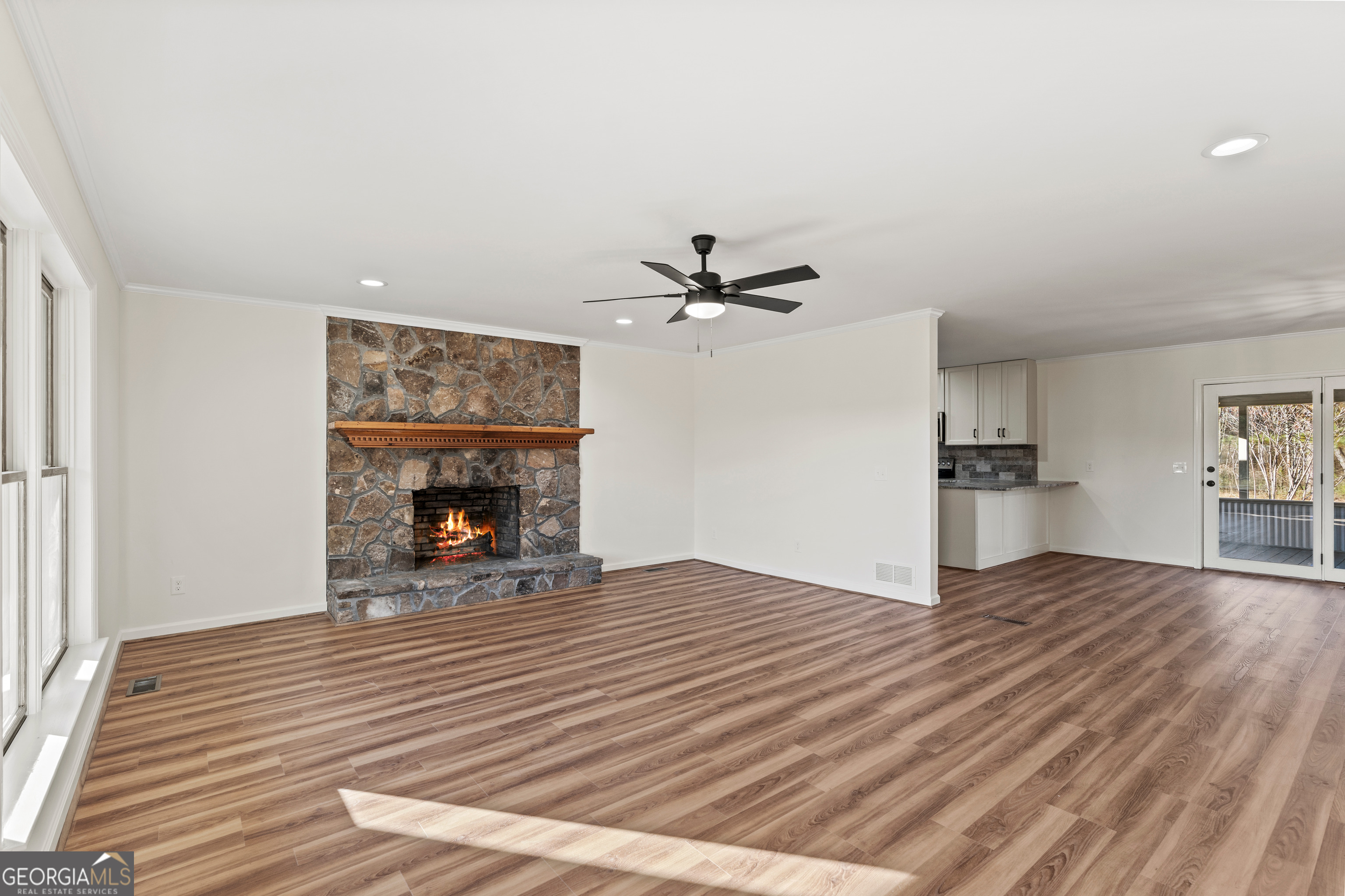 6421 Holly Springs Road Clermont, GA 30527 - Photo 14 of 58 a view of empty room with wooden floor and fireplace