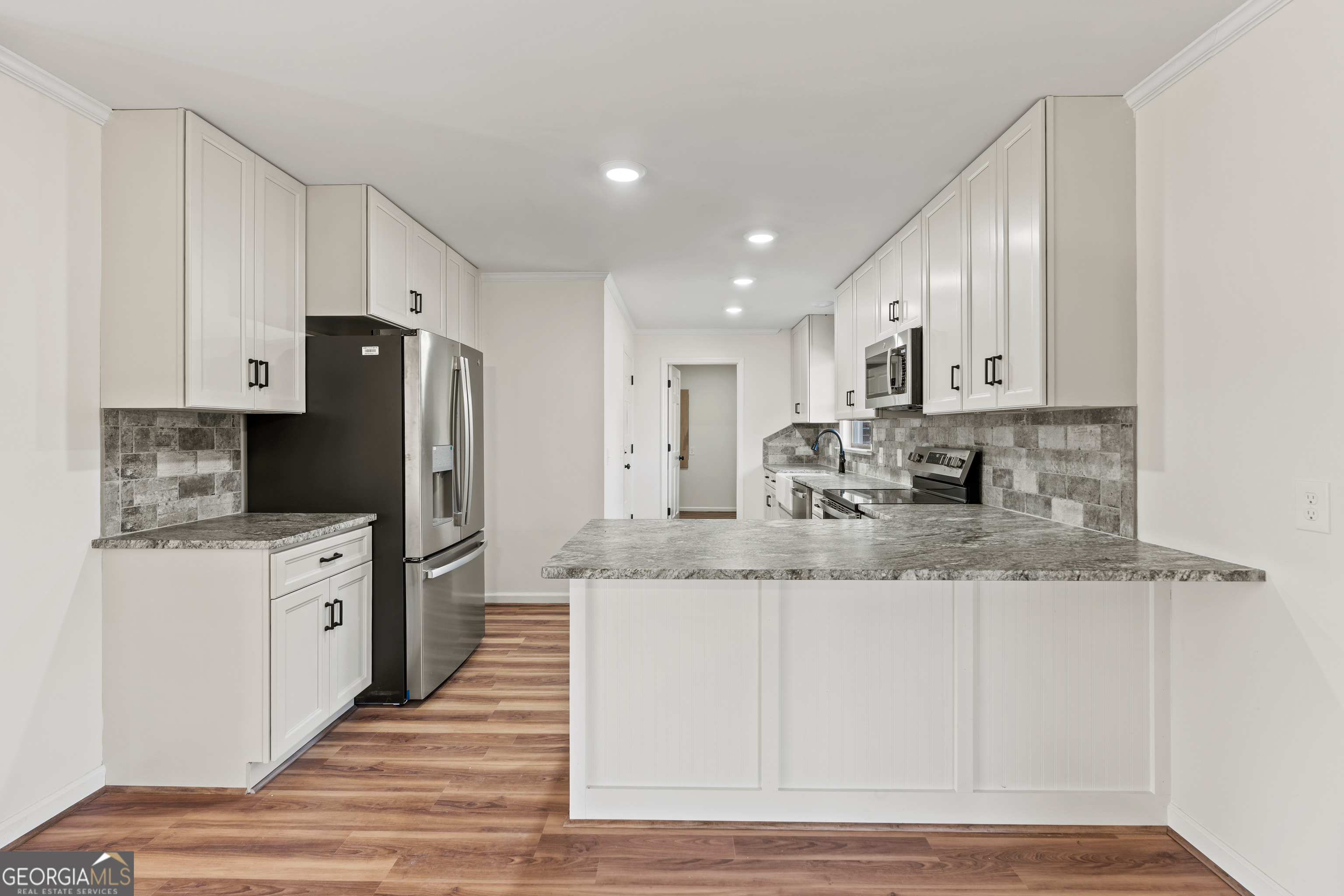 6421 Holly Springs Road Clermont, GA 30527 - Photo 18 of 58 a kitchen with stainless steel appliances granite countertop a refrigerator a stove and a sink