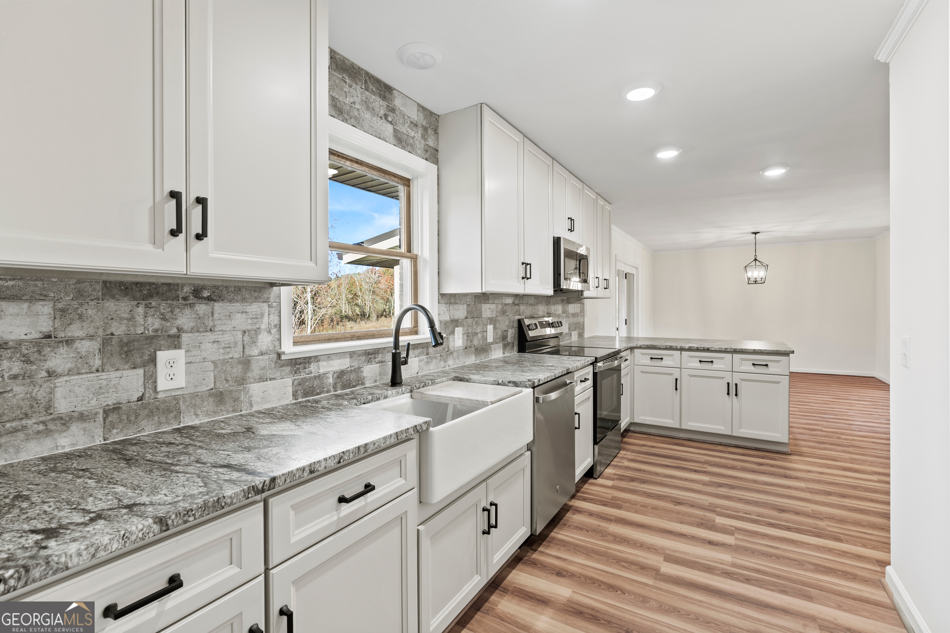 6421 Holly Springs Road Clermont, GA 30527 - Photo 21 of 58 a kitchen with white cabinets and white appliances