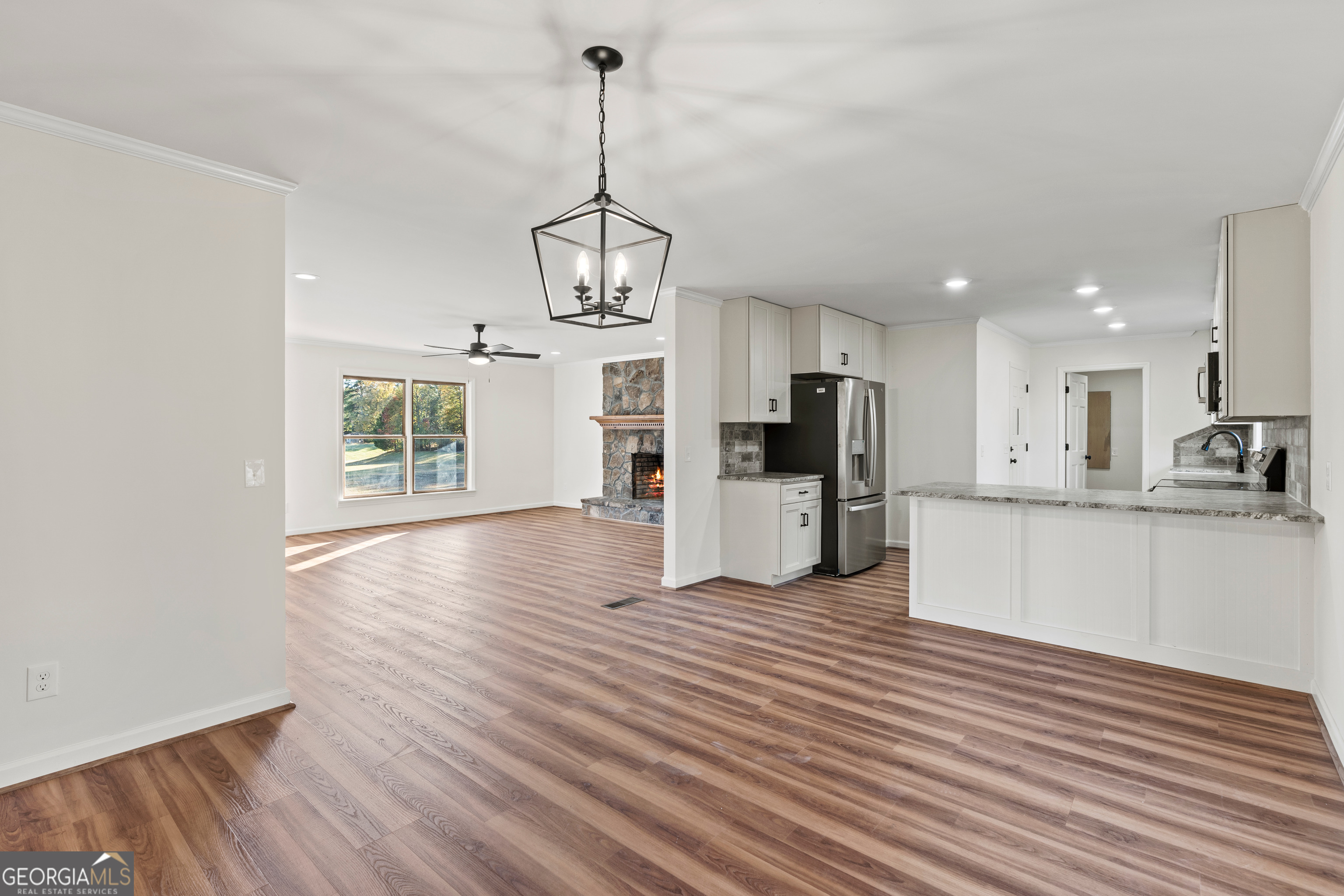 6421 Holly Springs Road Clermont, GA 30527 - Photo 24 of 58 a view of kitchen with granite countertop cabinets and refrigerator