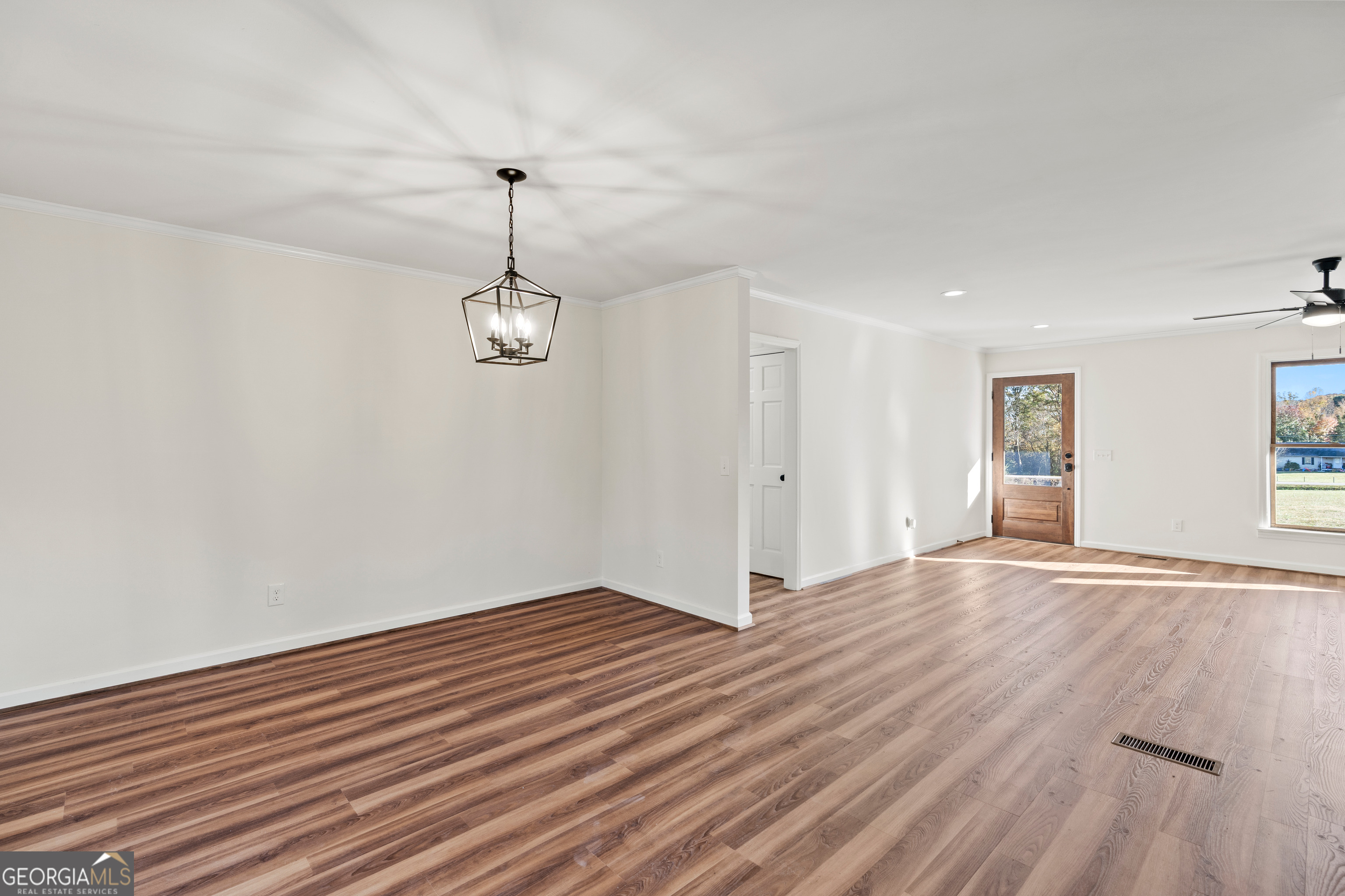 6421 Holly Springs Road Clermont, GA 30527 - Photo 27 of 58 a view of empty room with wooden floor and ceiling fan