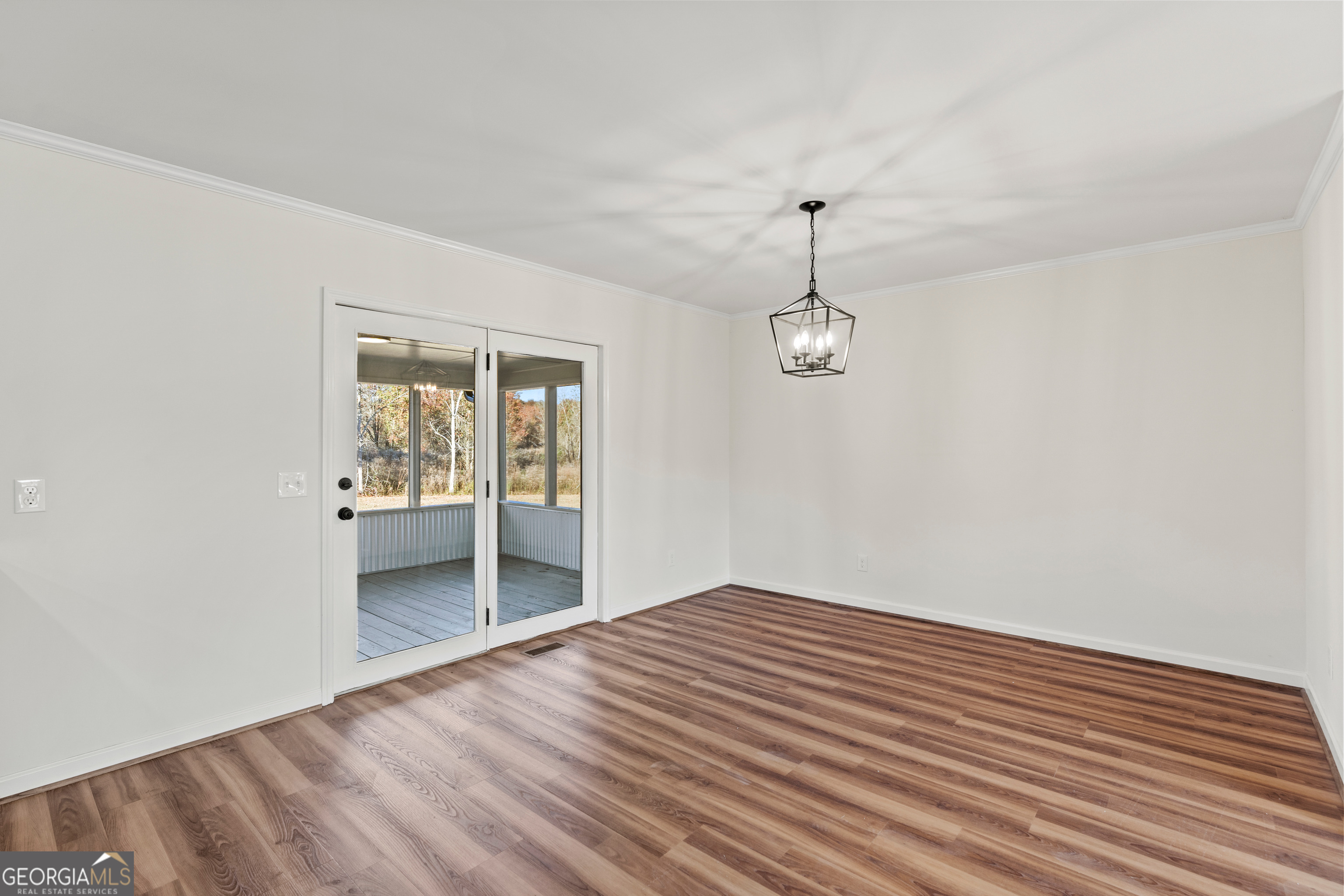6421 Holly Springs Road Clermont, GA 30527 - Photo 28 of 58 wooden floor in an empty room with a window