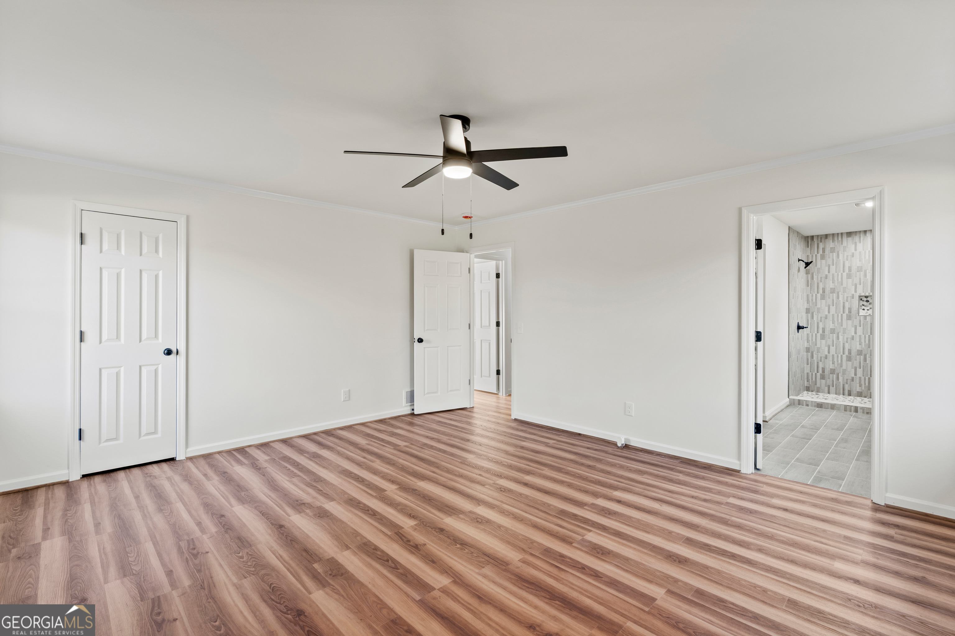 6421 Holly Springs Road Clermont, GA 30527 - Photo 29 of 58 a view of empty room with wooden floor and fan