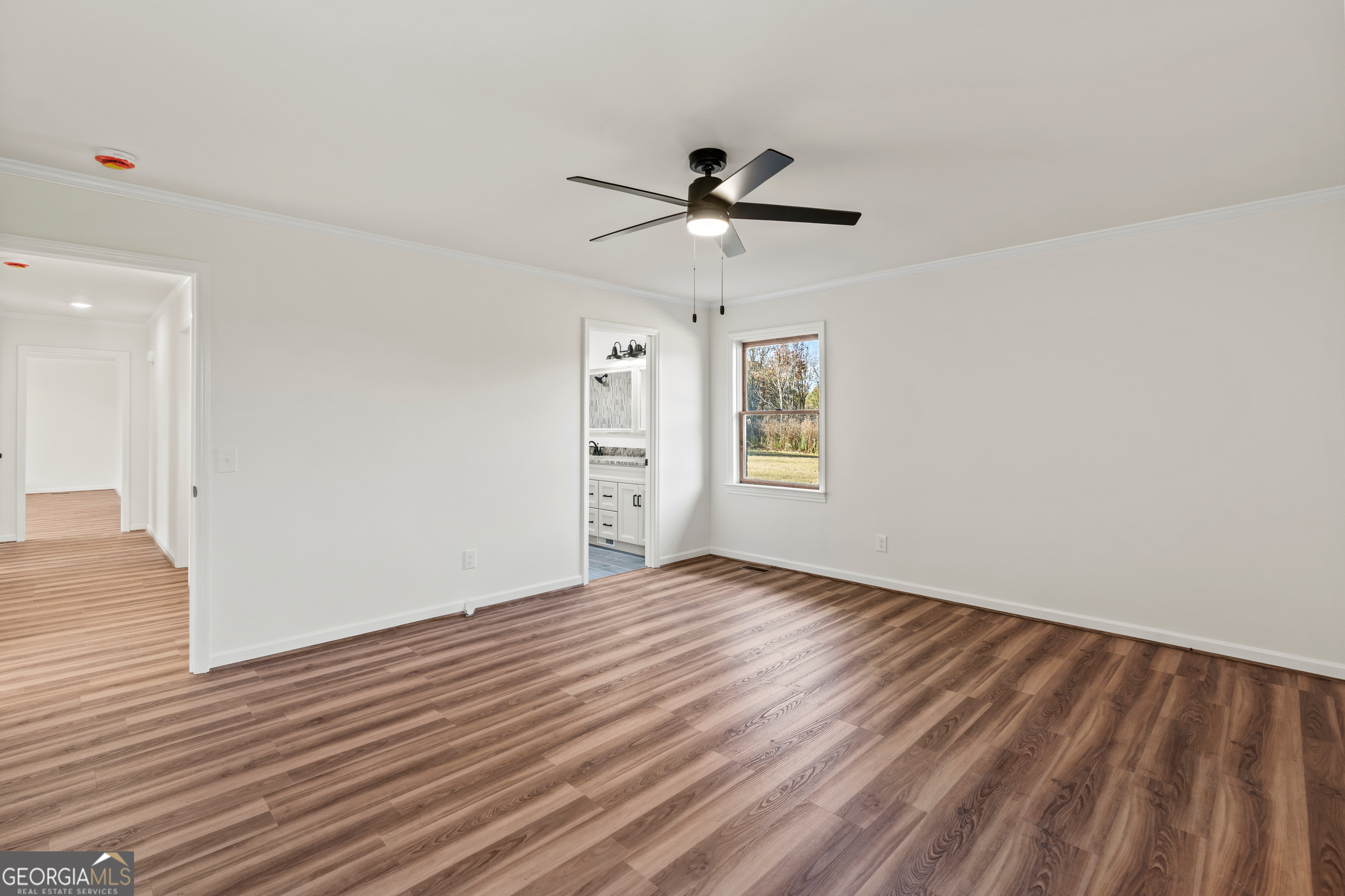 6421 Holly Springs Road Clermont, GA 30527 - Photo 30 of 58 a view of empty room with wooden floor and fan