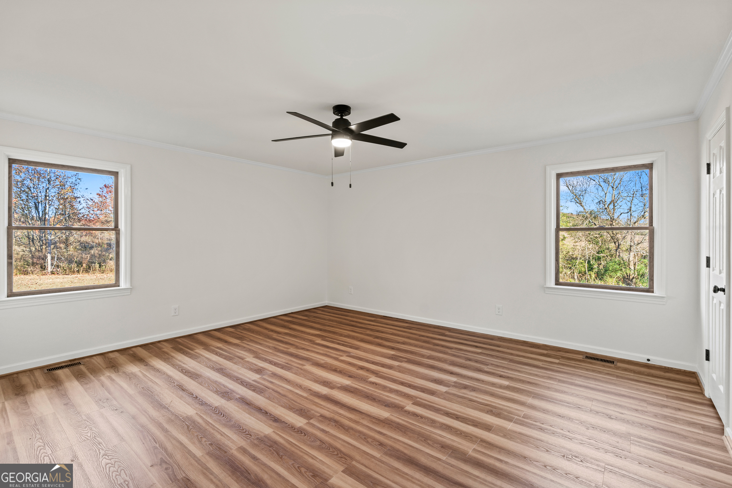 6421 Holly Springs Road Clermont, GA 30527 - Photo 31 of 58 a view of room with hardwood floor and ceiling fan