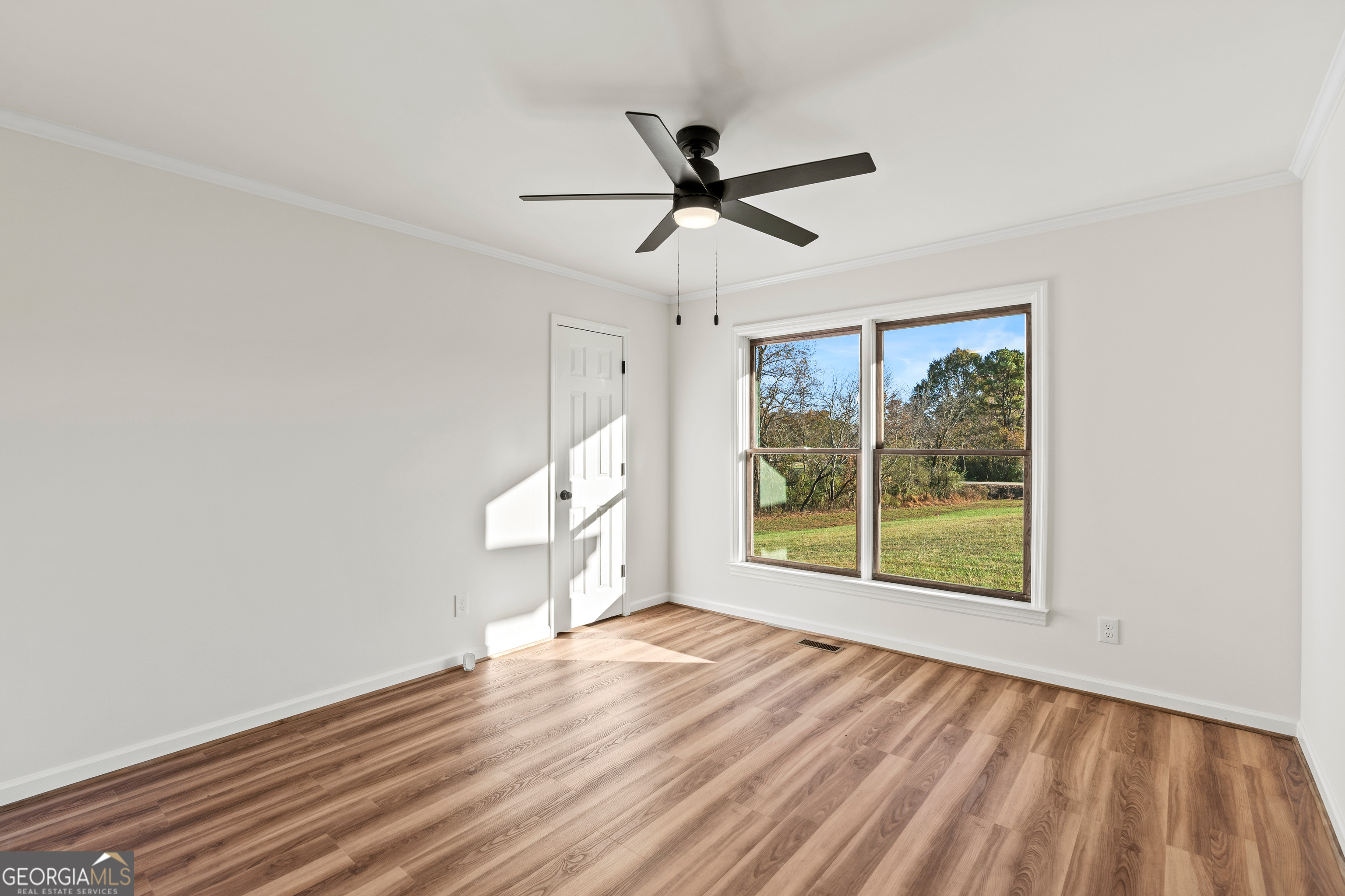 6421 Holly Springs Road Clermont, GA 30527 - Photo 35 of 58 a view of empty room with wooden floor and fan
