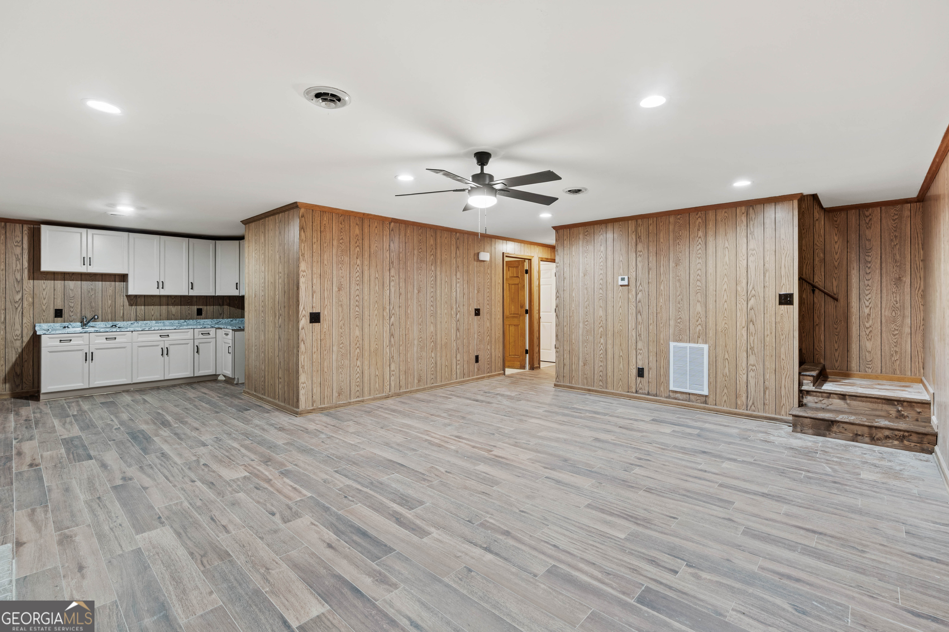 6421 Holly Springs Road Clermont, GA 30527 - Photo 38 of 58 a view of a kitchen with a sink and a refrigerator