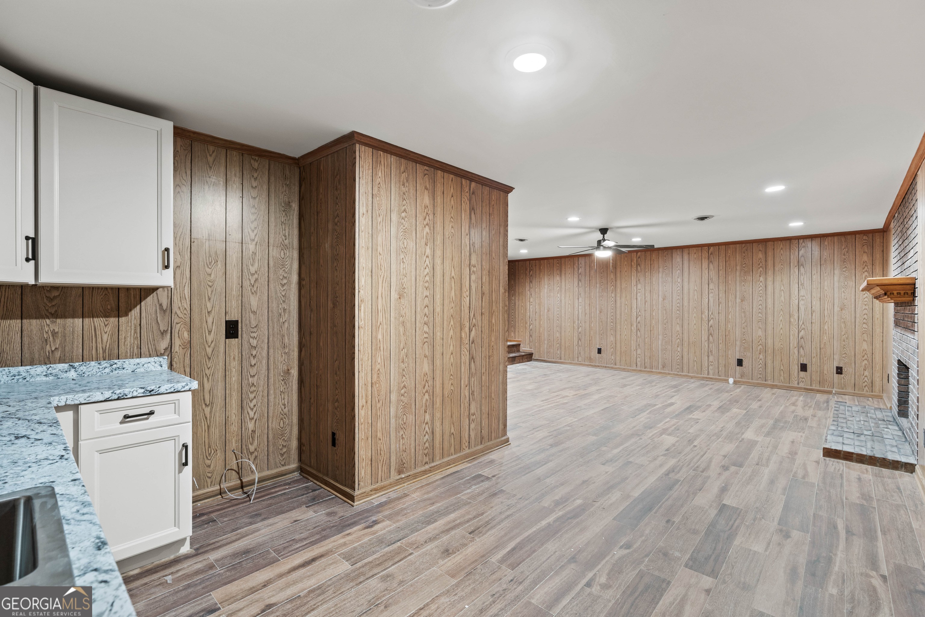 6421 Holly Springs Road Clermont, GA 30527 - Photo 41 of 58 a view of a kitchen with a sink and wooden floor