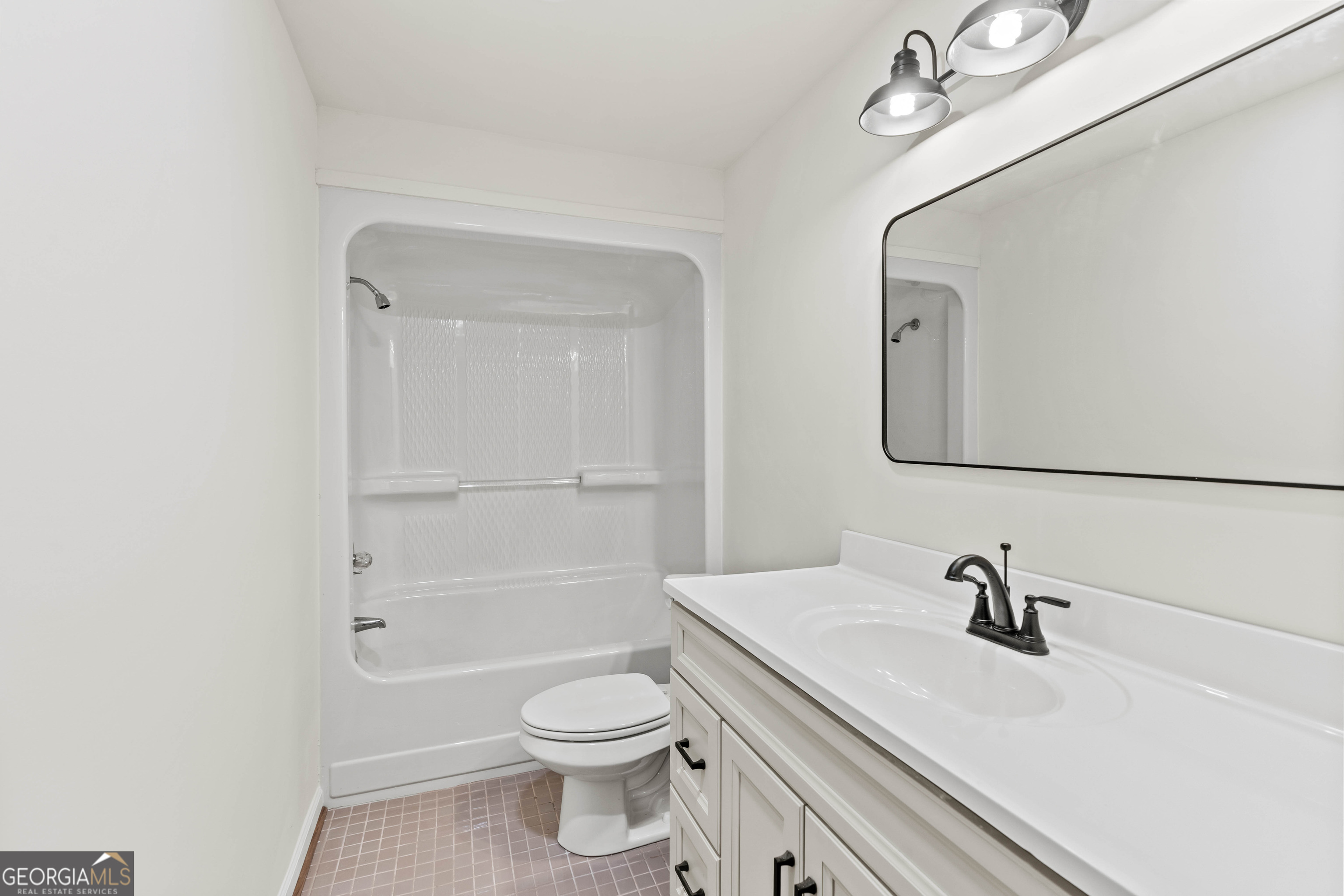 6421 Holly Springs Road Clermont, GA 30527 - Photo 46 of 58 a bathroom with a sink a toilet and shower