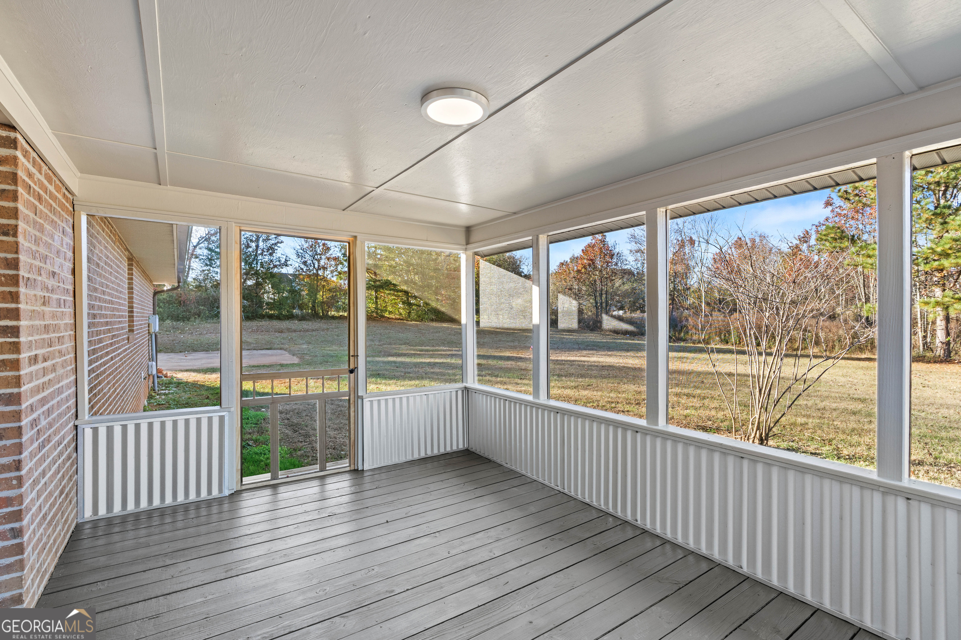 6421 Holly Springs Road Clermont, GA 30527 - Photo 50 of 58 a view of an empty room with wooden floor and a window