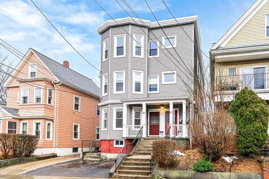 a front view of a residential apartment building with a yard