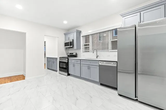 a kitchen with stainless steel appliances granite countertop a refrigerator and a sink