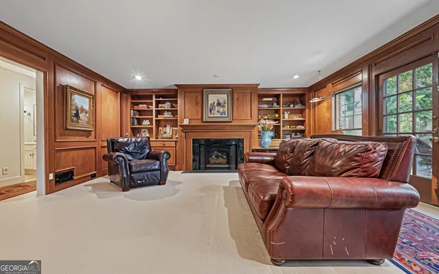 a view of an empty room with wooden floor and windows