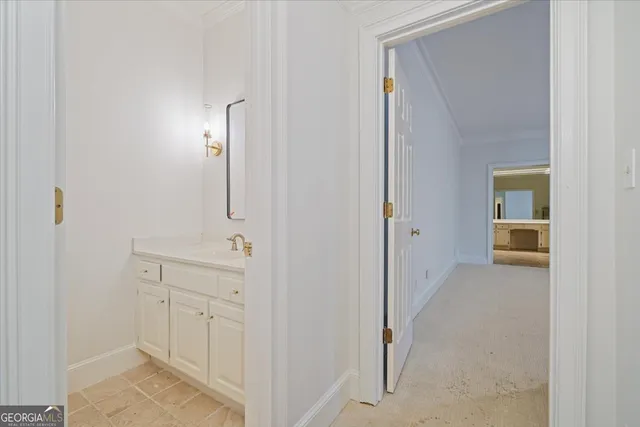 a large white kitchen with a stove a refrigerator and a sink