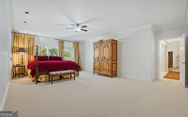 a spacious bathroom with a tub sink and mirror