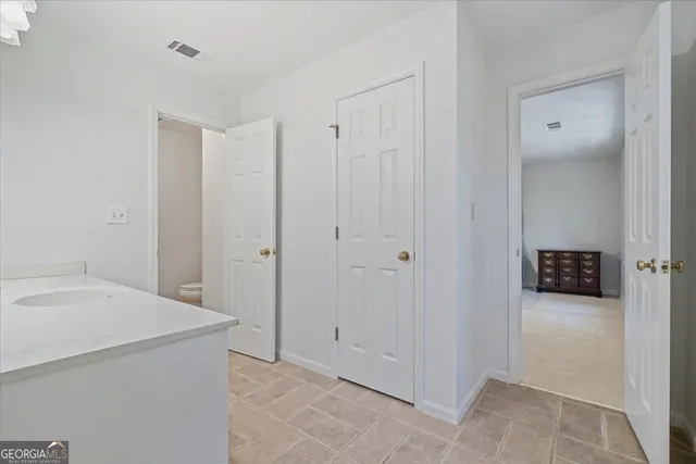 a spacious bathroom with a double vanity sink a mirror and shower