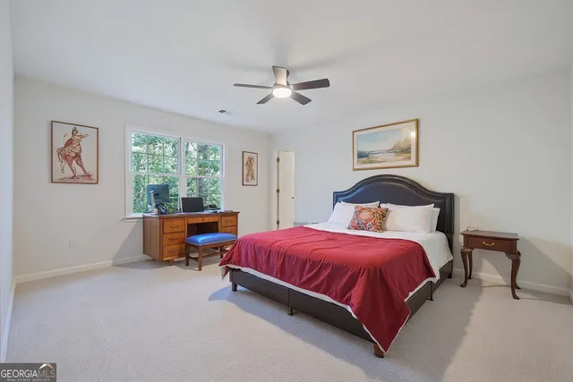 a view of a house with large trees