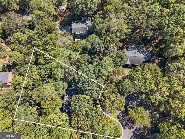 a view of a swimming pool with lawn chairs under an umbrella