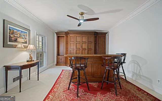 a living room with a table and a rug