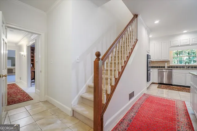 a kitchen with granite countertop white cabinets and white appliances